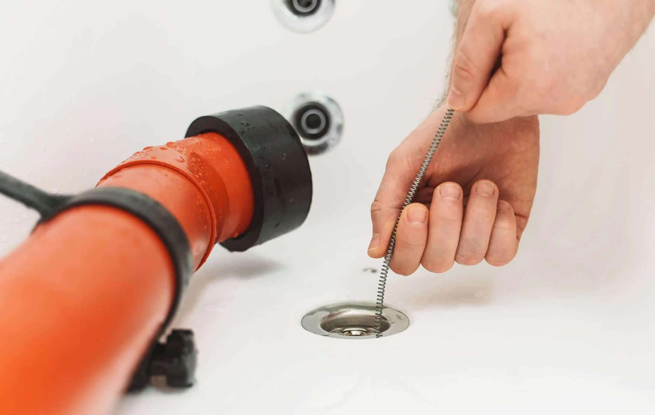 Drain auger being used on a sink