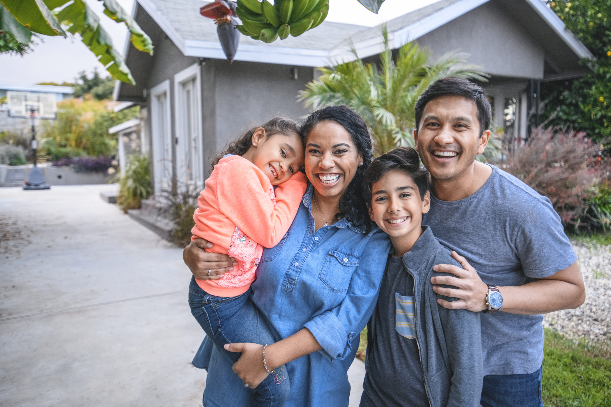 A happy family outside of their home