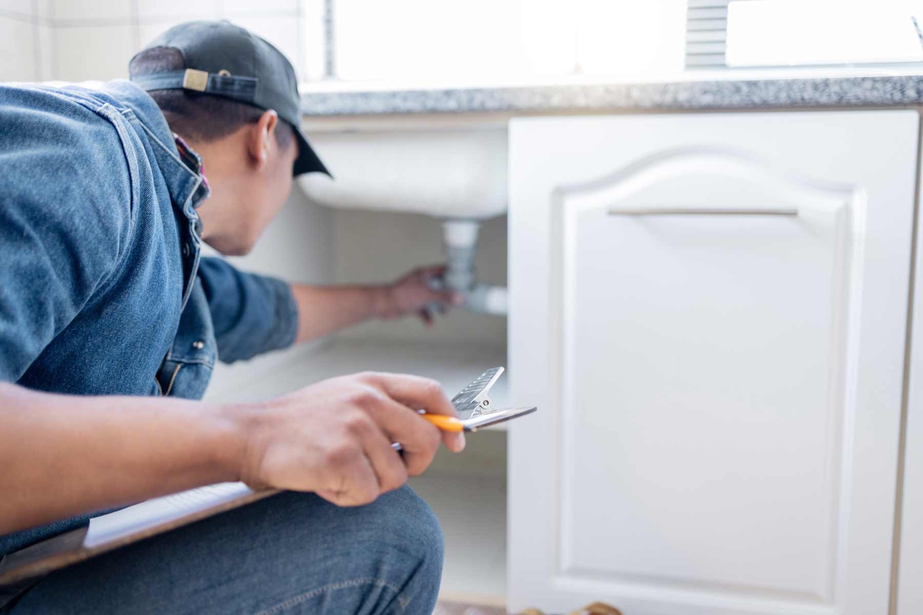 A plumber performing a plumbing inspection